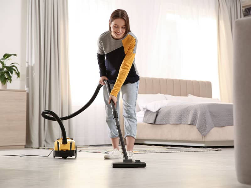 Woman using vacuum cleaner