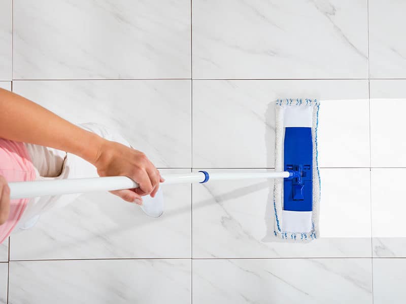 Female Cleaning White Floor