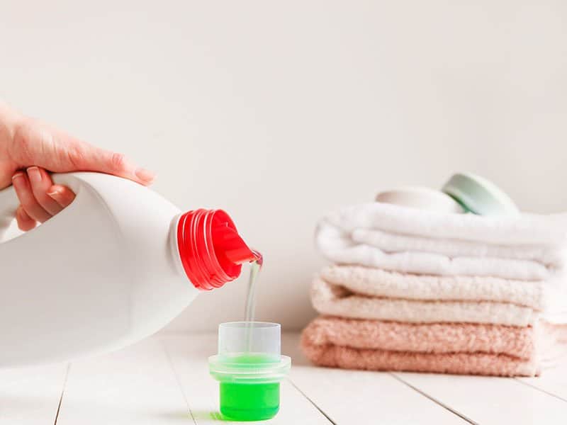 Hands Pouring Liquid Laundry