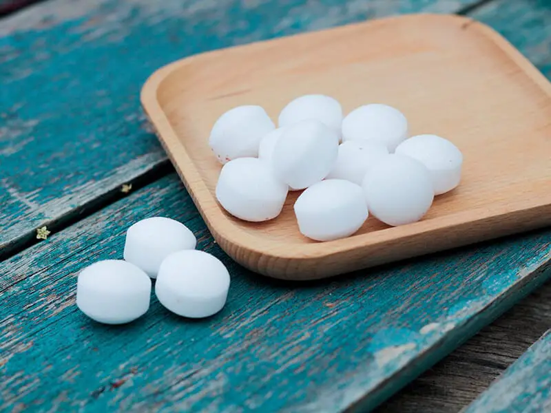 Mothballs on Wooden Plate